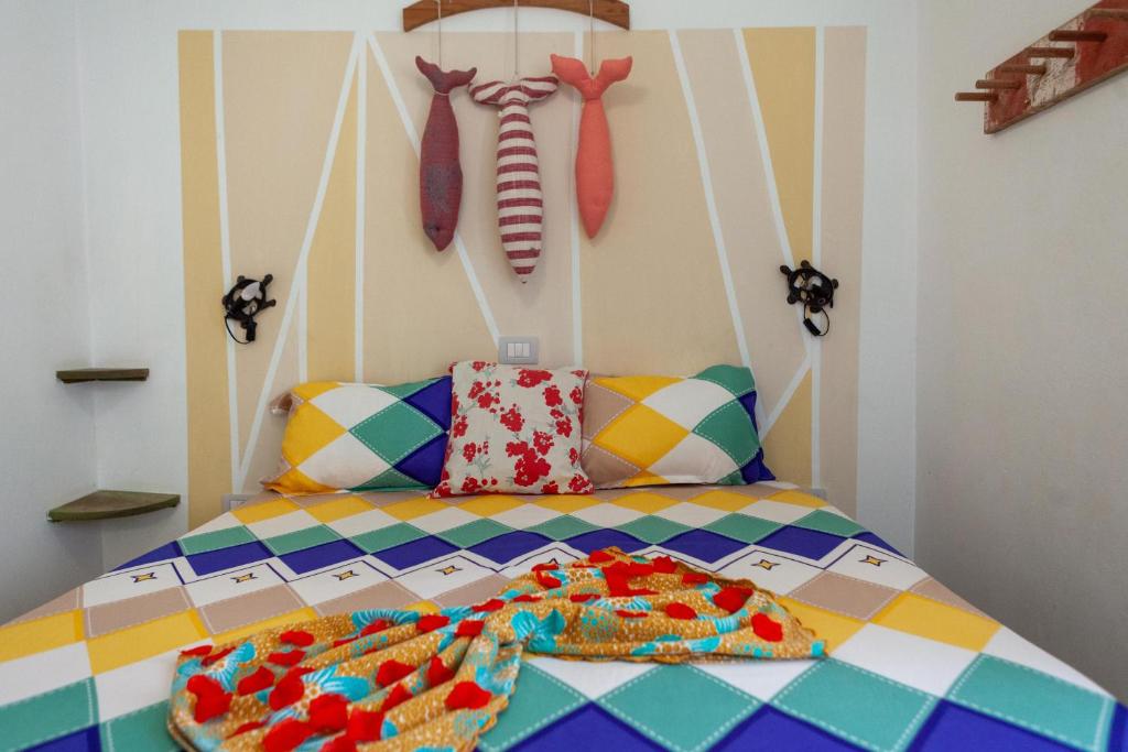 a bedroom with a bed with ties on the wall at Casa Carlotta Maio in Vila do Porto