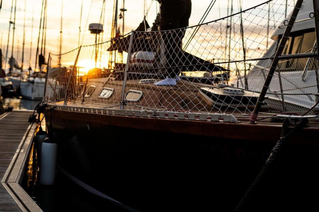 un barco está atracado en un muelle con la puesta de sol en The Captains Locker - 30ft Yacht, en San Miguel de Abona