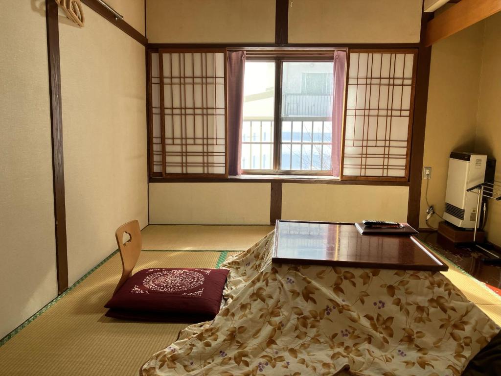 Postel nebo postele na pokoji v ubytování Takasagoya Ryokan