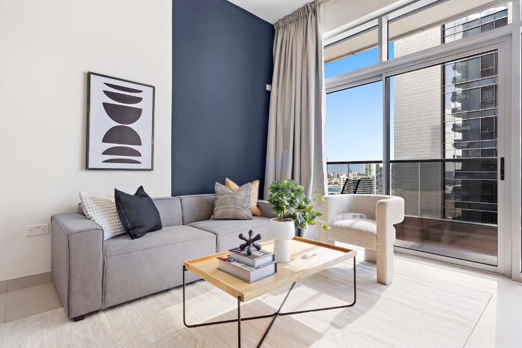 阿布扎比Silkhaus Luxury 1 BDR Close To Reem Central Park的带沙发和大窗户的客厅