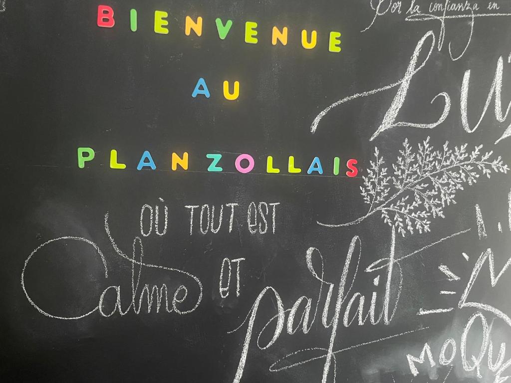 a chalkboard with writing on it with a flower on it at Le Planzollais in Planzolles