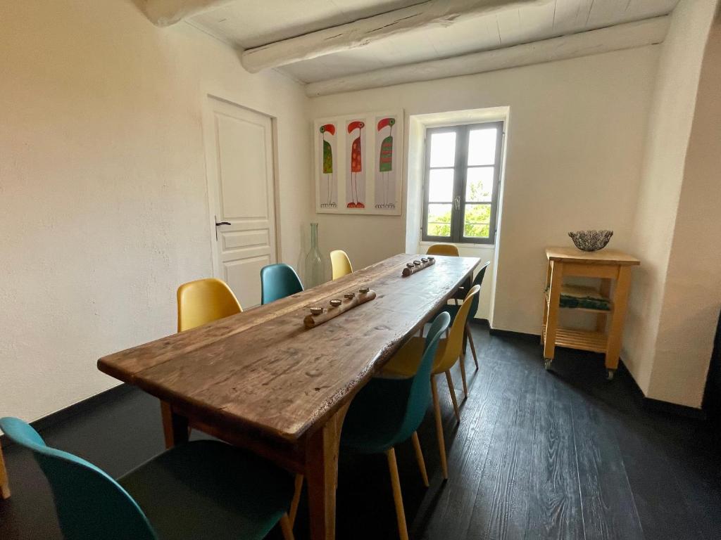 a dining room with a wooden table and chairs at Le Planzollais in Planzolles