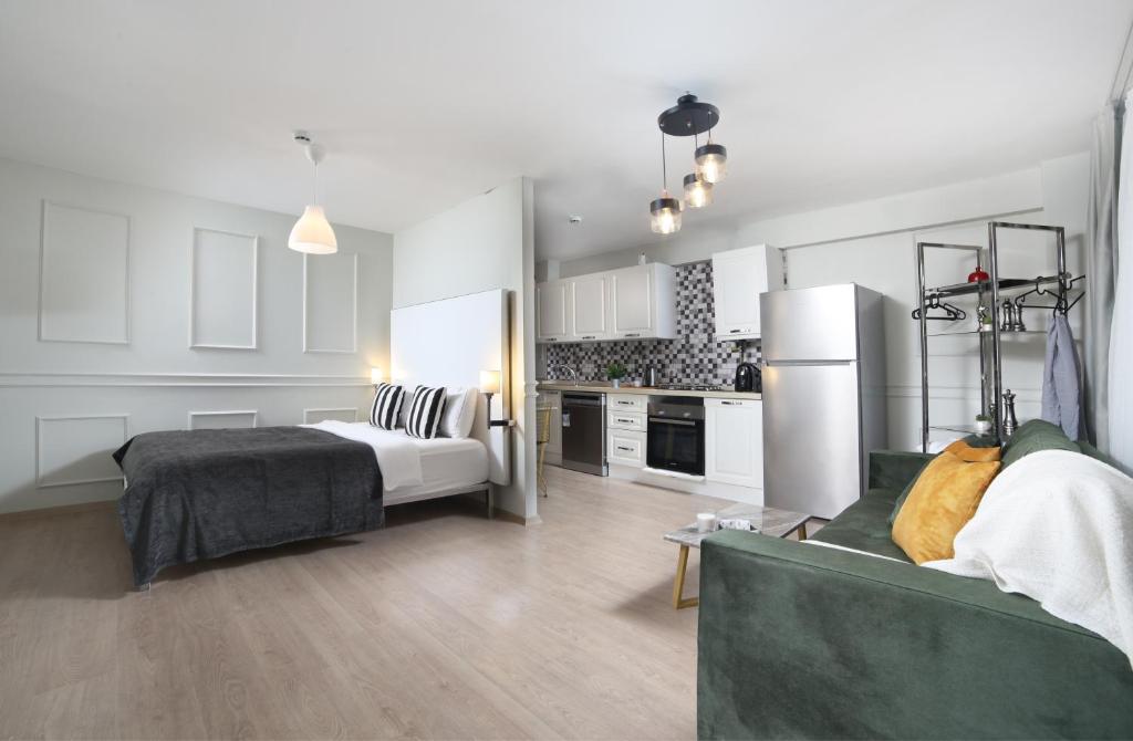 a living room with a bed and a kitchen at Beddington Residence Sisli in Istanbul