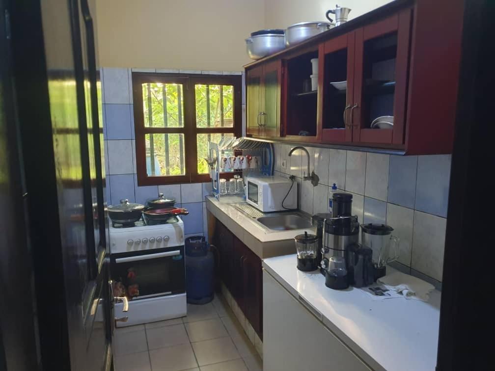 a kitchen with a sink and a stove top oven at Village des Aviateurs 