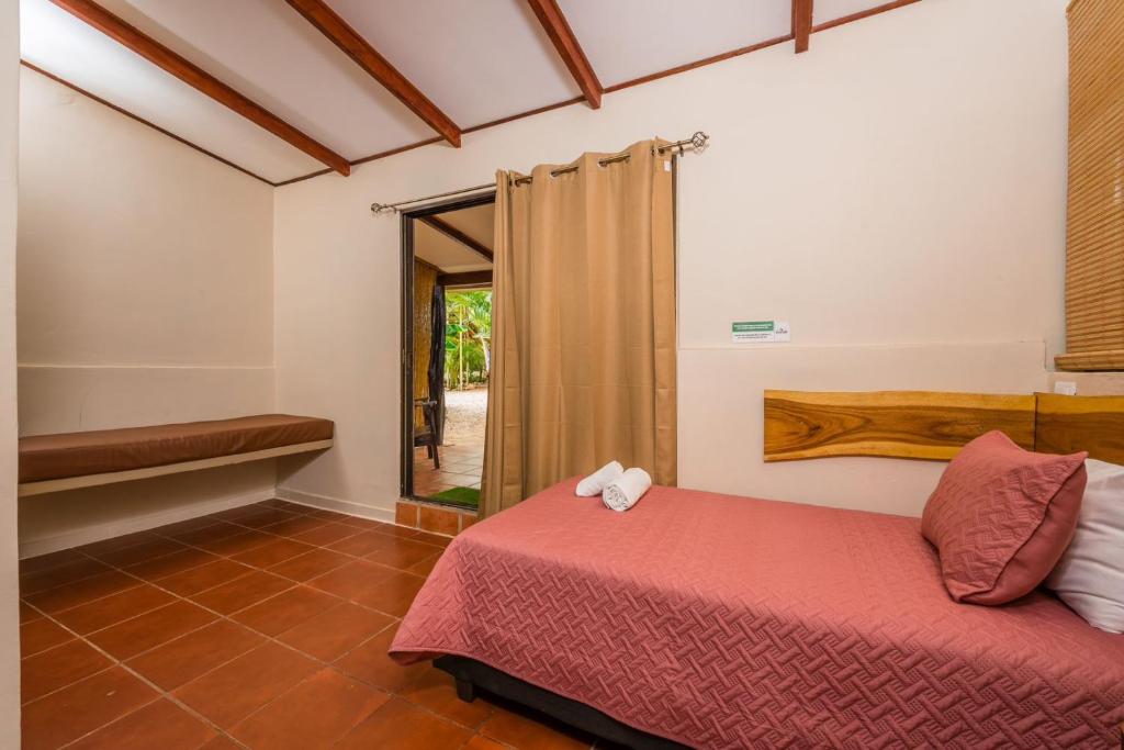 Postel nebo postele na pokoji v ubytování Casa Tropical Playa Grande