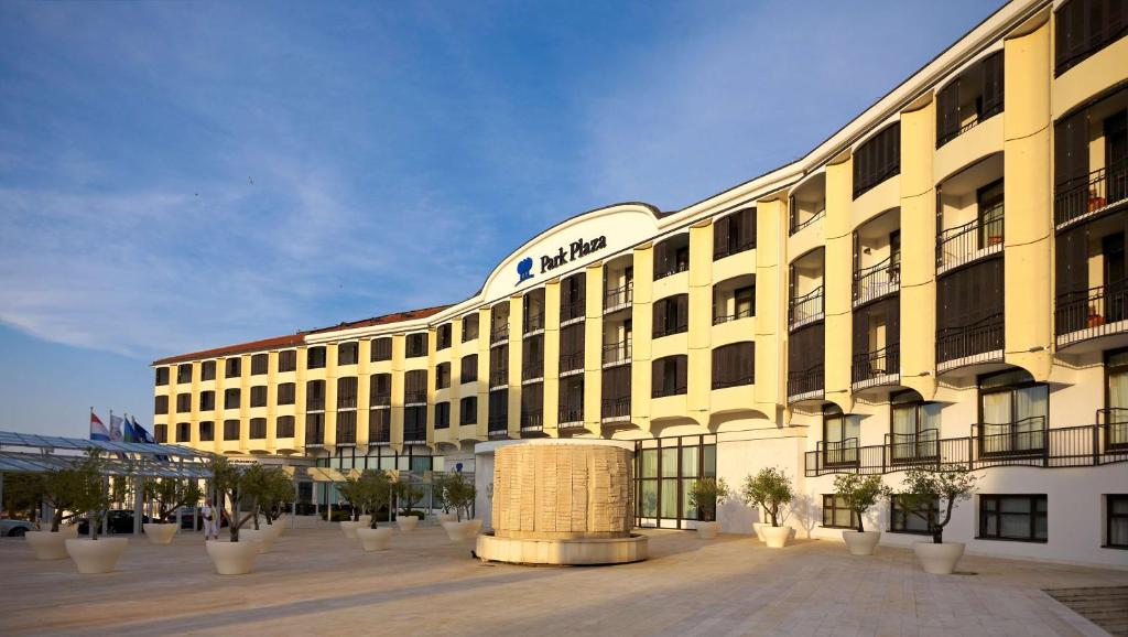 a large yellow building with a sign on it at Park Plaza Histria Pula in Pula