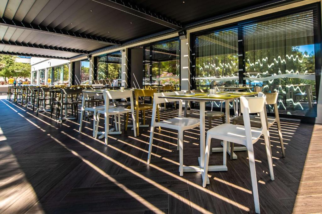 a row of tables and chairs on a patio at Park Plaza Arena Pula in Pula