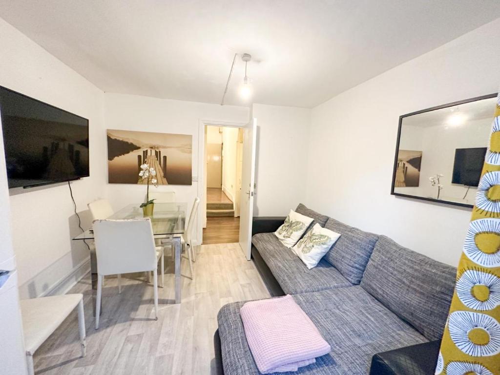 a living room with a couch and a table at Fernandos Flats! Stunning Soho Apartments, meters from Piccadilly Circus, 2 Beds in London