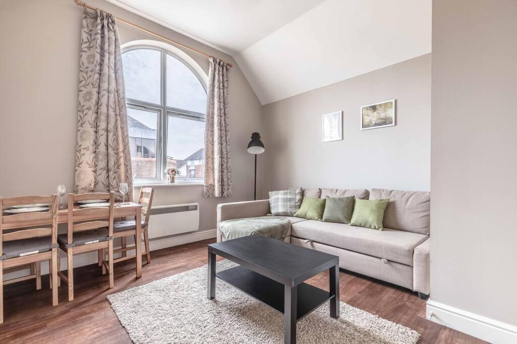a living room with a couch and a table at Cosy Central Windsor Apartment , Parking in Windsor