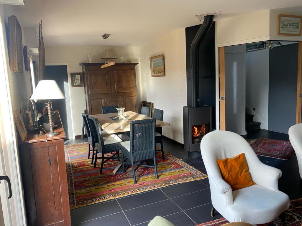 une salle à manger avec une table et des chaises et une cheminée dans l'établissement Maison cosy en plein cœur de Saint-Malo, à Saint-Malo