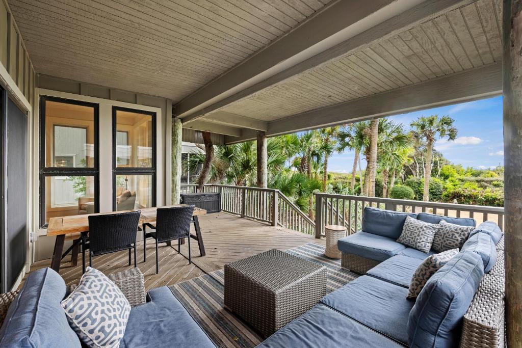 a living room with a blue couch on a deck at SS3510: 3510 Seascape in Kiawah Island