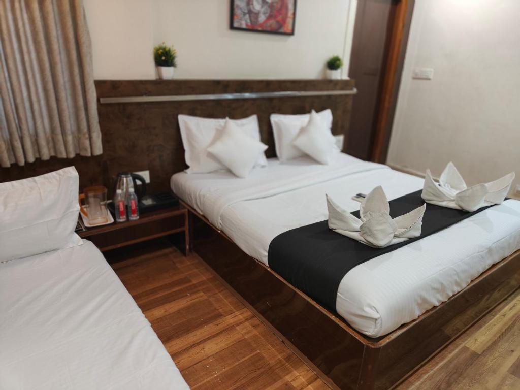 Postel nebo postele na pokoji v ubytování Kiara Shirdi Park Inn
