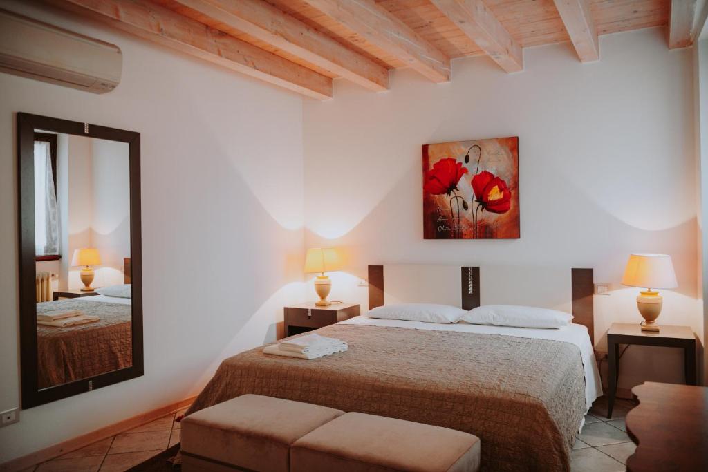 - une chambre avec 2 lits et un tableau mural dans l'établissement CAMPOLIVO ECOLODGES All HOUSE, à Gargnano