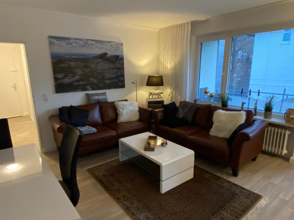 een woonkamer met een bank en een salontafel bij Ferienwohnung KatzenTraum in Bad Harzburg