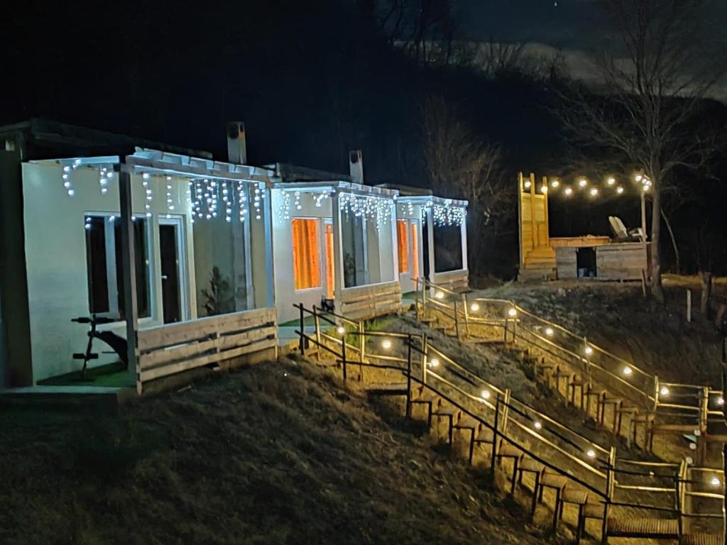 a tiny house with lights on it at night at Bungalow Casa Corbilor in Stăneşti