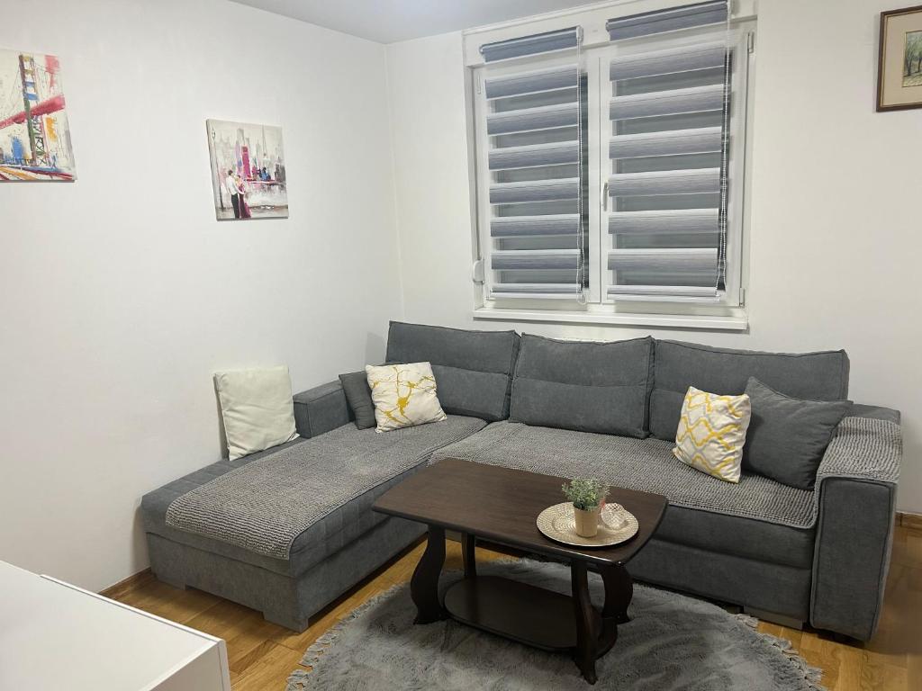uma sala de estar com um sofá e uma mesa em Apartment Mija-Meri em Tuzla