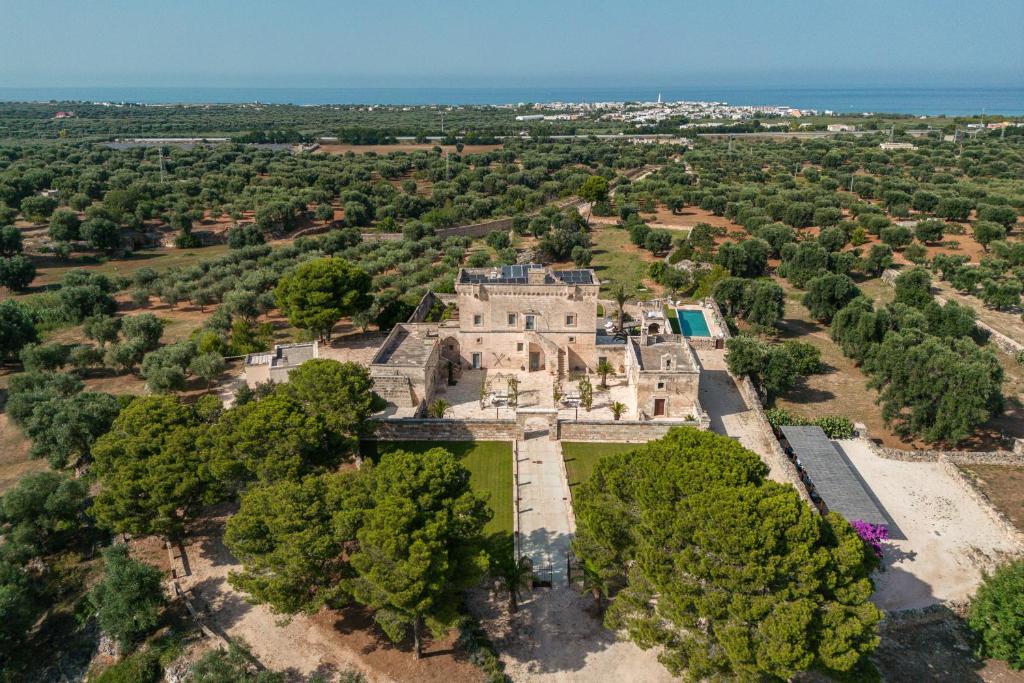 an aerial view of an old castle with trees at Masseria Torrelonga in Fasano