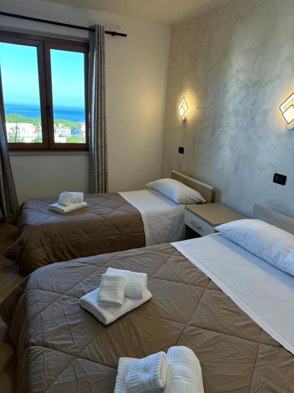 a hotel room with two beds with towels on them at Scilla e Cariddi in Scilla