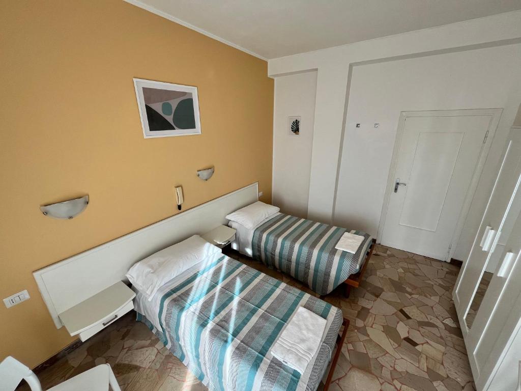Ліжко або ліжка в номері Hotel Parini