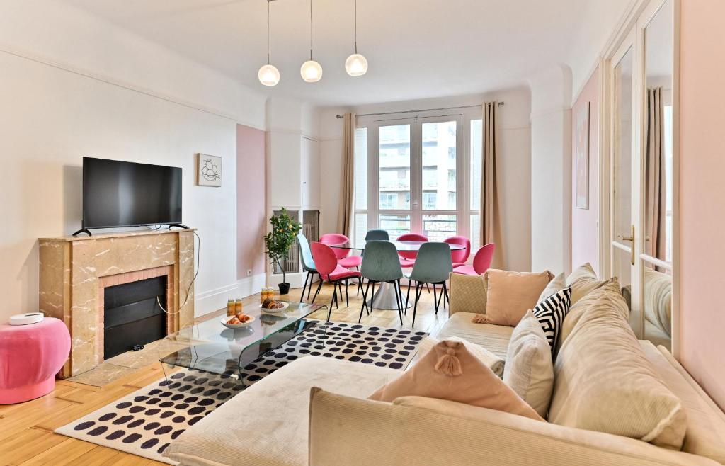 a living room with a couch and a fireplace at Appartement luxueux Porte Maillot - Neuilly -II in Neuilly-sur-Seine