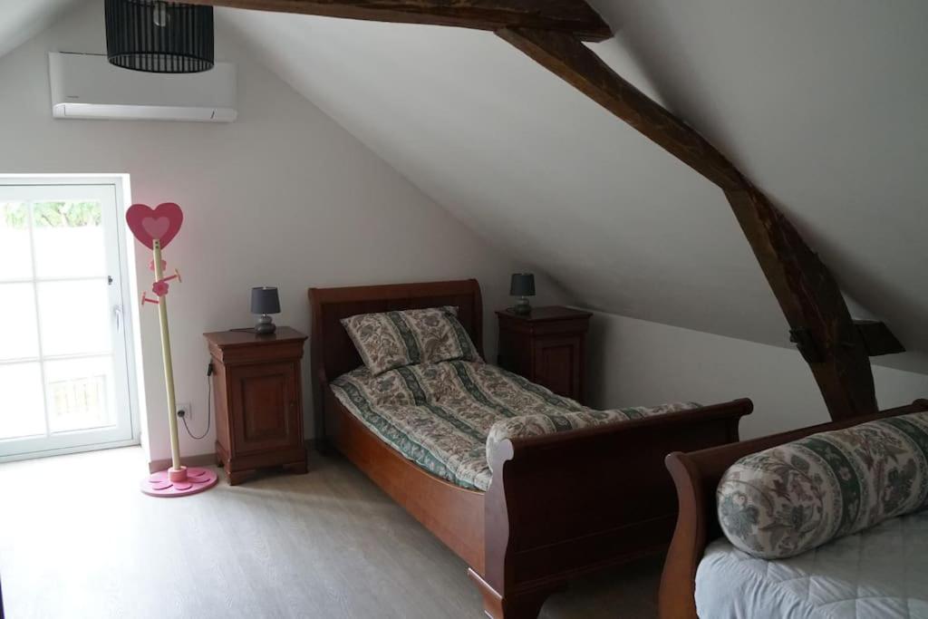 um quarto com uma cama, um sofá e uma janela em Gîte Aliénor en Anjou em Vernoil