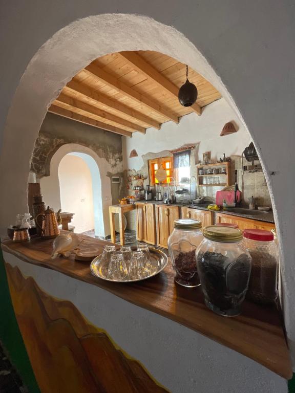 a kitchen with a counter with bowls and vases on it at Live the bedouinlife in Nuweiba