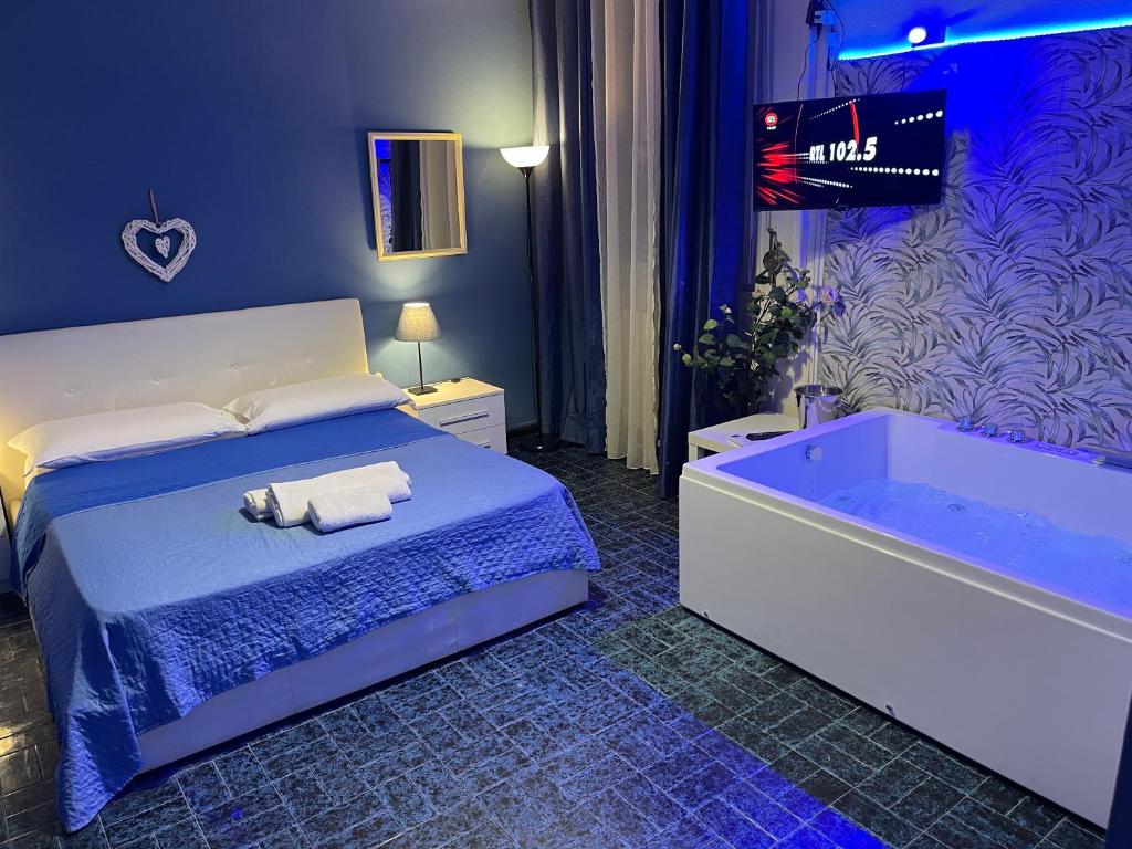 a bedroom with a bed and a bath tub at Etnea Glamour House in Catania