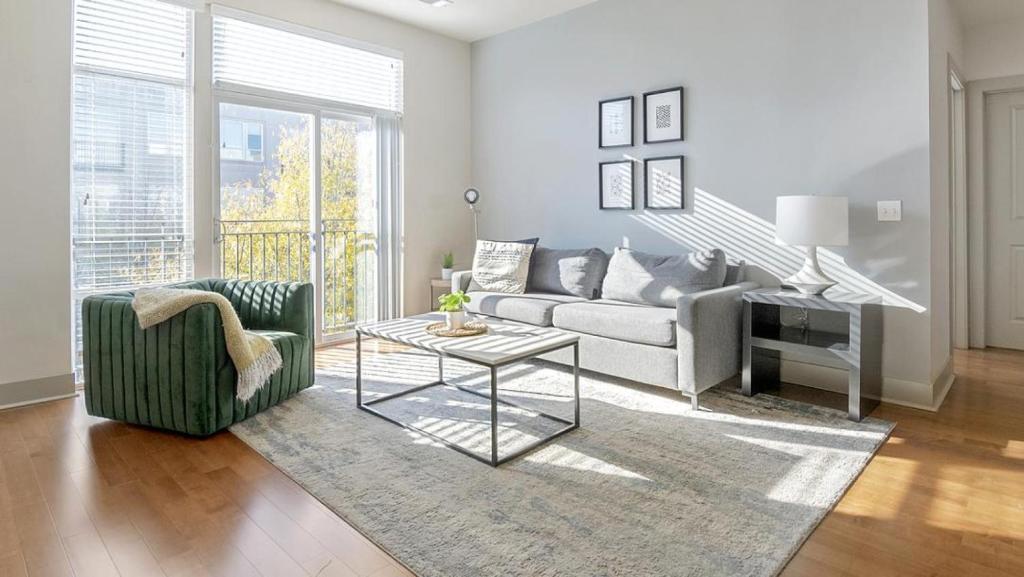 a living room with a couch and a table at Landing Modern Apartment with Amazing Amenities (ID2205) in Baltimore