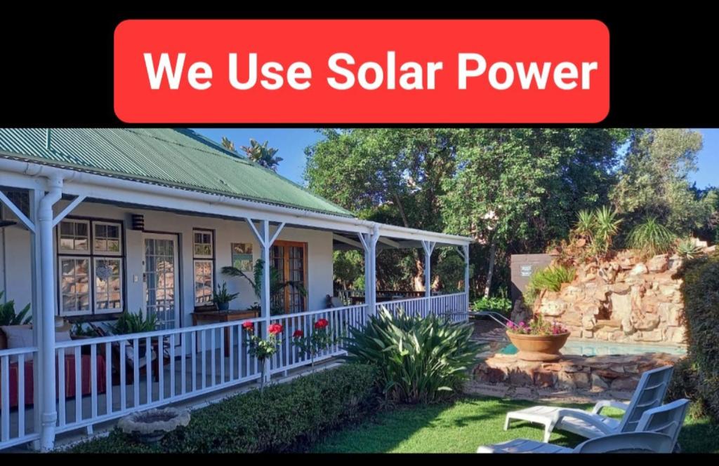 a house with a sign that says we use solar power at Best Little Guesthouse -Beit Shalom in Oudtshoorn
