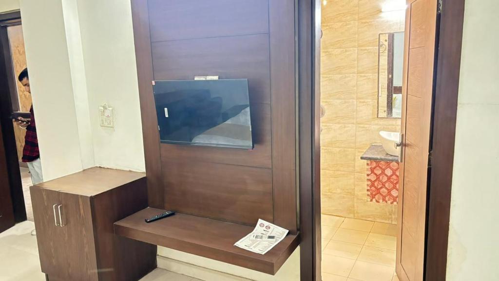 a bathroom with a television in a room at Hotel Green Lotus By Dsy Hospitality in Noida