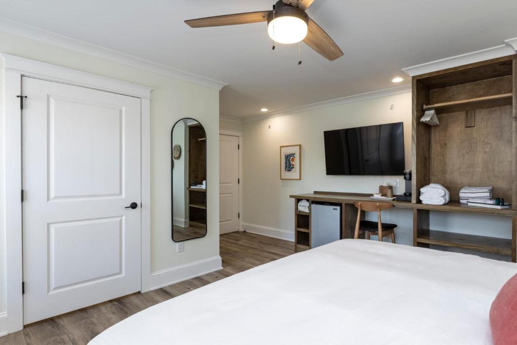 a bedroom with a bed and a flat screen tv at Albermarle #202 Inn at Old Beach in Virginia Beach
