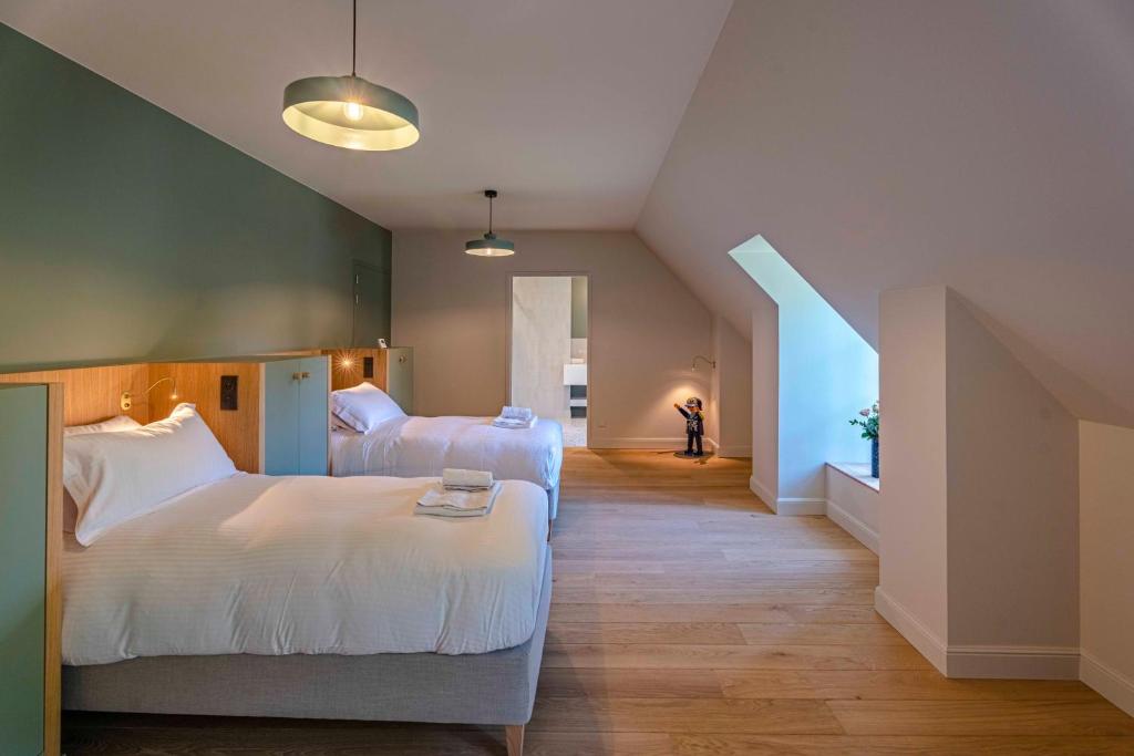 a hotel room with two beds and a staircase at Bayeux, Normandy, Private Mansion, 17th-18th century, in the city in Bayeux