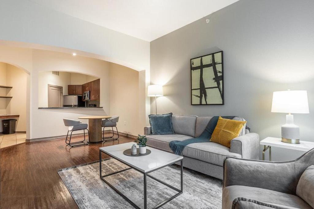 a living room with a couch and a table at Landing Modern Apartment with Amazing Amenities (ID1649X92) in Houston