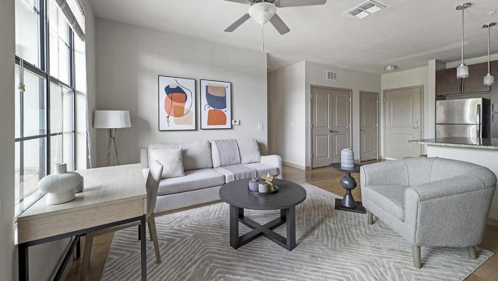a living room with a couch and a chair and a table at Landing Modern Apartment with Amazing Amenities (ID9660X22) in Orlando