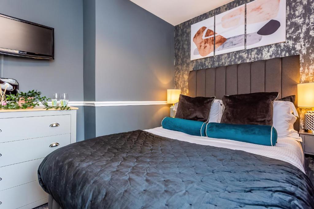 a bedroom with a large bed and a tv at Room 02 - Sandhaven Rooms Double in South Shields