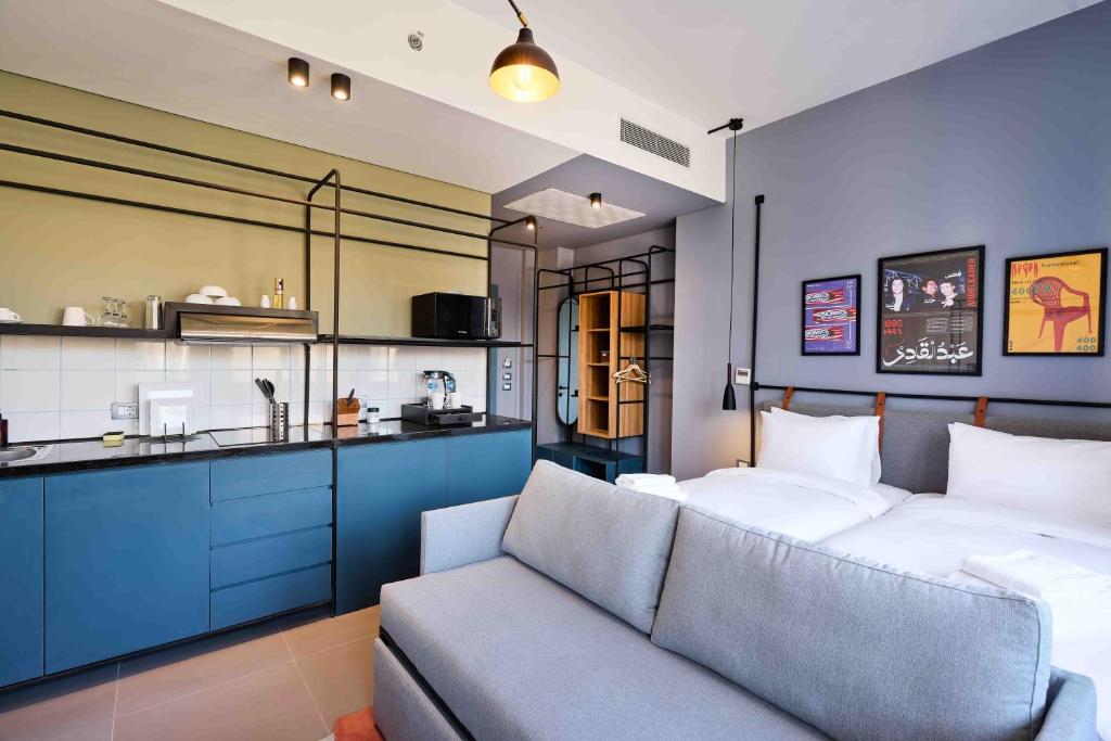 a living room with a bed and a couch at Brassbell l DT l Hannaux l Tahrir sq in Cairo