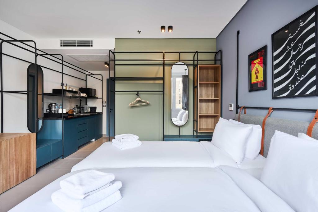 a bedroom with two beds and a kitchen at Brassbell l DT l Hannaux l Tahrir sq in Cairo