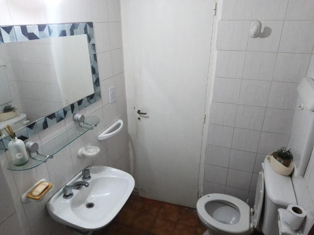 a bathroom with a sink and a toilet and a mirror at Barrio Norte hermoso apart privado in San Miguel de Tucumán