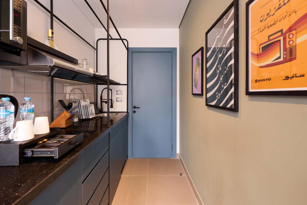 a kitchen with a blue door and a counter at Brassbell l DT l Hannaux l Tahrir sq in Cairo