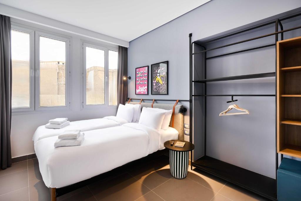 a bedroom with a large white bed and a closet at Brassbell l DT l Hannaux l Tahrir sq in Cairo