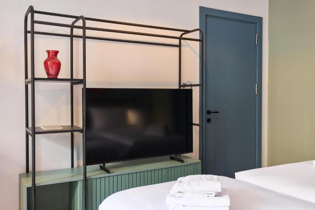 a bedroom with a bunk bed with a flat screen tv at Brassbell l DT l Hannaux l Tahrir sq in Cairo