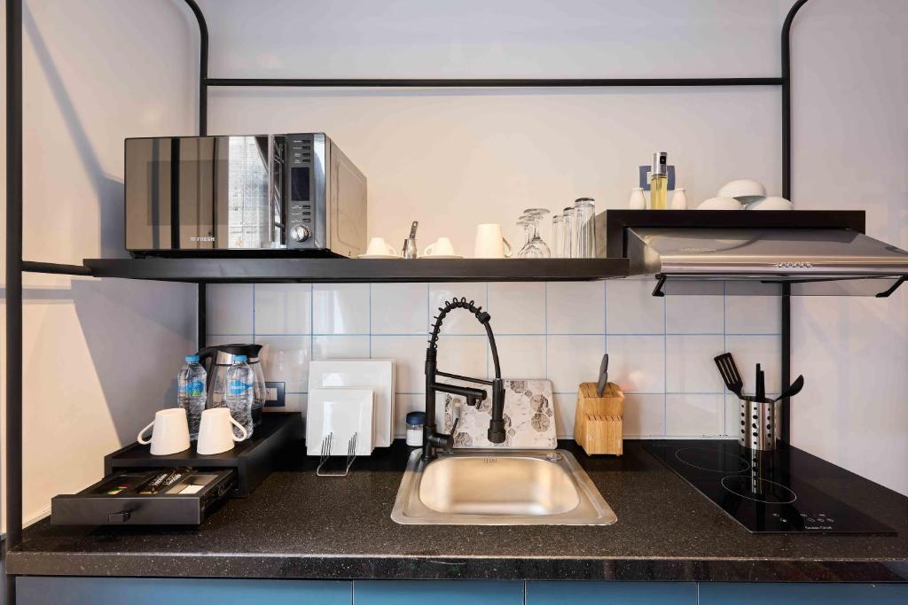 a kitchen counter with a sink and a microwave at Brassbell l DT l Hannaux l Tahrir sq in Cairo