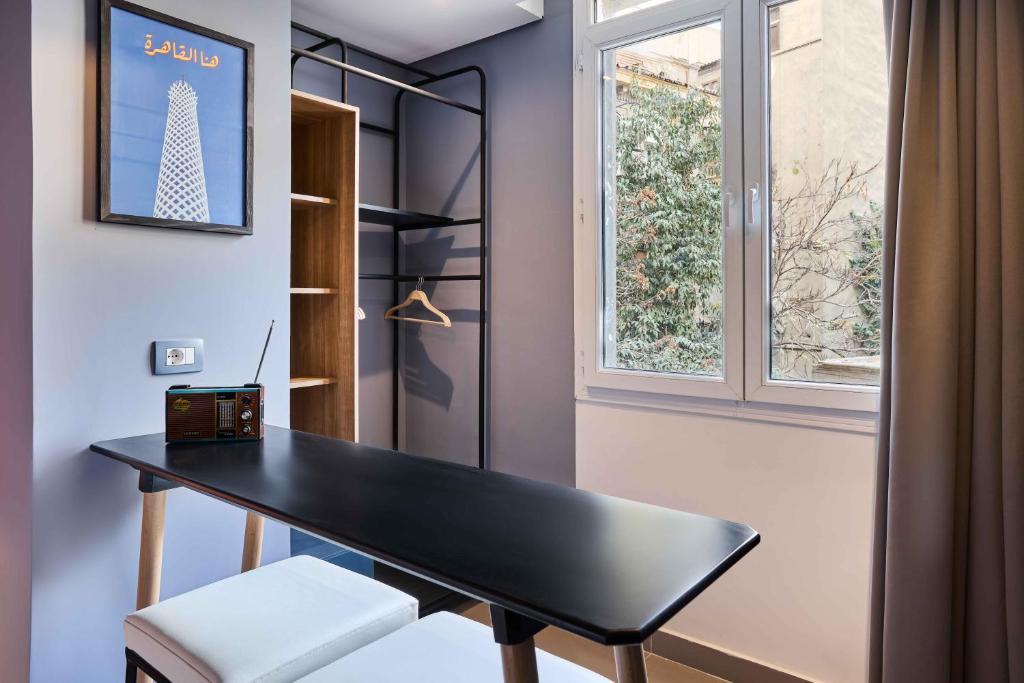 a black desk in a room with a window at Brassbell l DT l Hannaux l Tahrir sq in Cairo