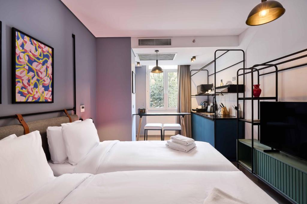 a hotel room with two beds and a tv at Brassbell l DT l Hannaux l Tahrir sq in Cairo