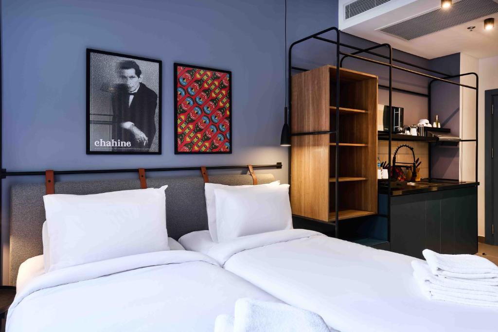 a bedroom with a white bed and a blue wall at Brassbell l DT l Hannaux l Tahrir sq in Cairo