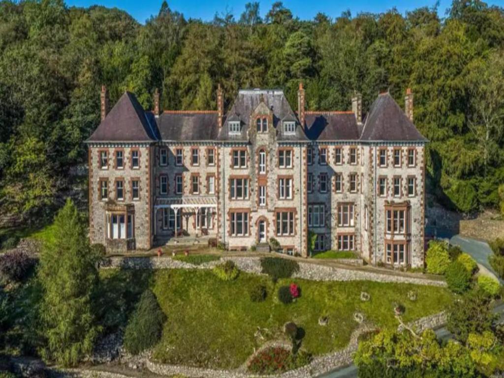 an aerial view of a large mansion with trees at Pass the Keys Olive Tree Lovely Apartment with Sea Views in Grange Over Sands