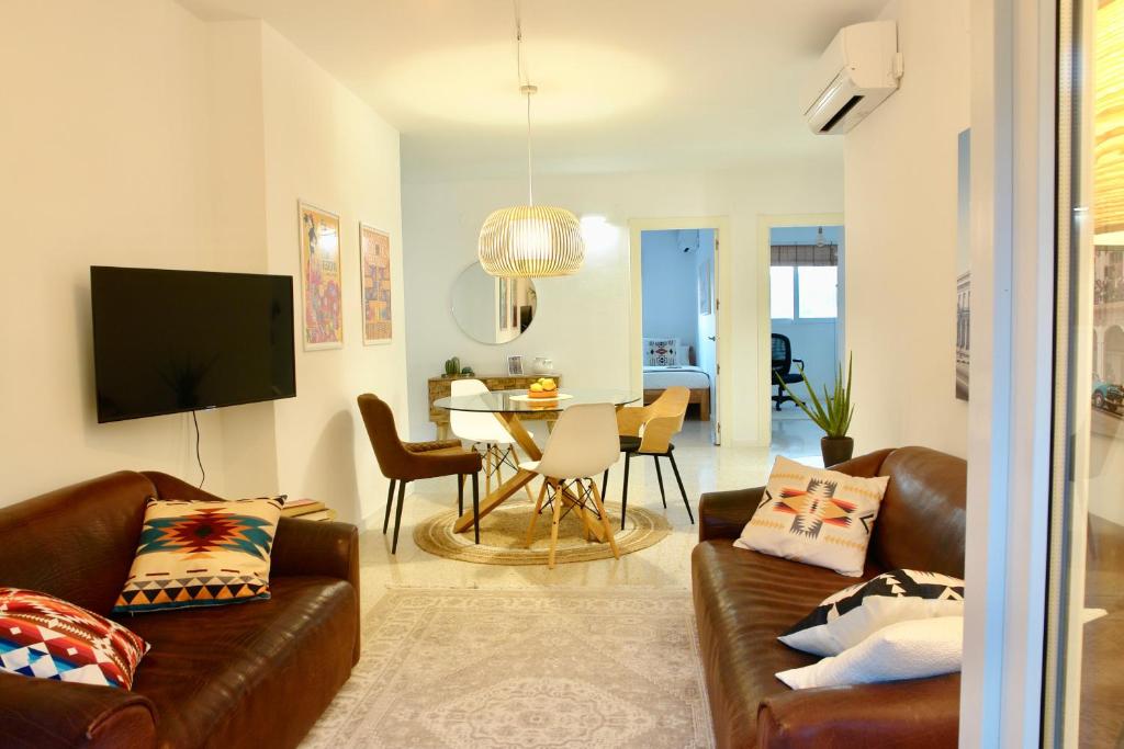 a living room with a couch and a table at Large appartement with great views in Málaga