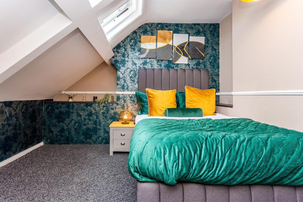a bedroom with a bed with green sheets and yellow pillows at Room 06 - Sandhaven Rooms Double in South Shields