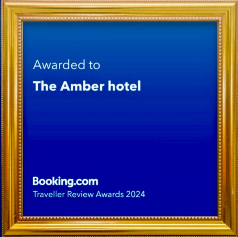 a gold picture frame with the words awarded to the amber hotel at The Amber hotel in Ambikāpur