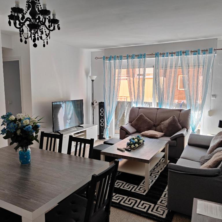a living room with a table and a couch at Relaxed Space in the beach in Puerto de Sagunto